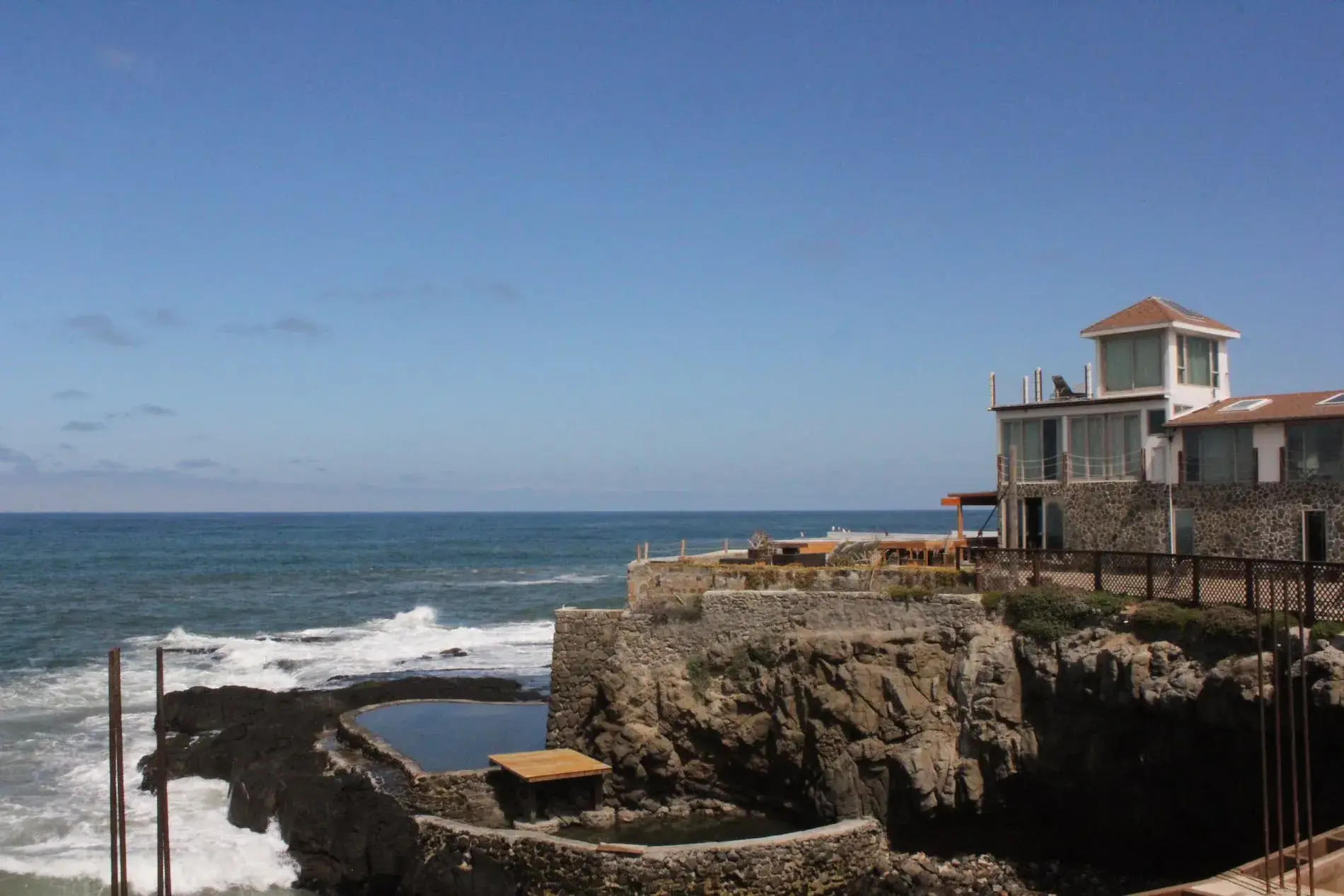 Cover for video. Drone view: Santa Maria clinic building, ocean pool, ocean