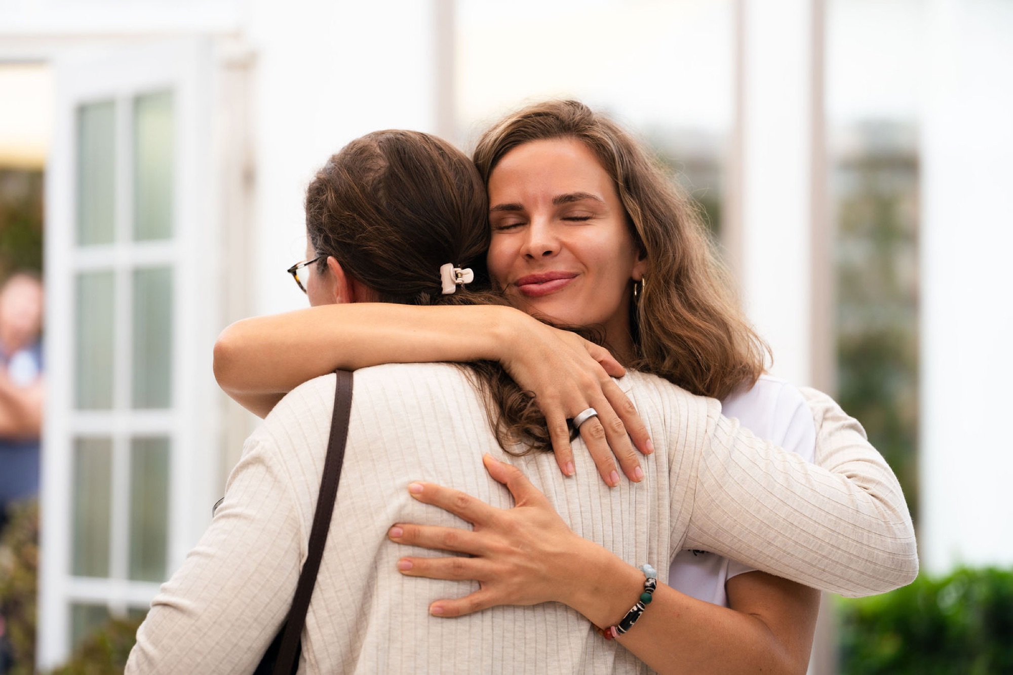 A patient says goodbye to Mariya with a hug